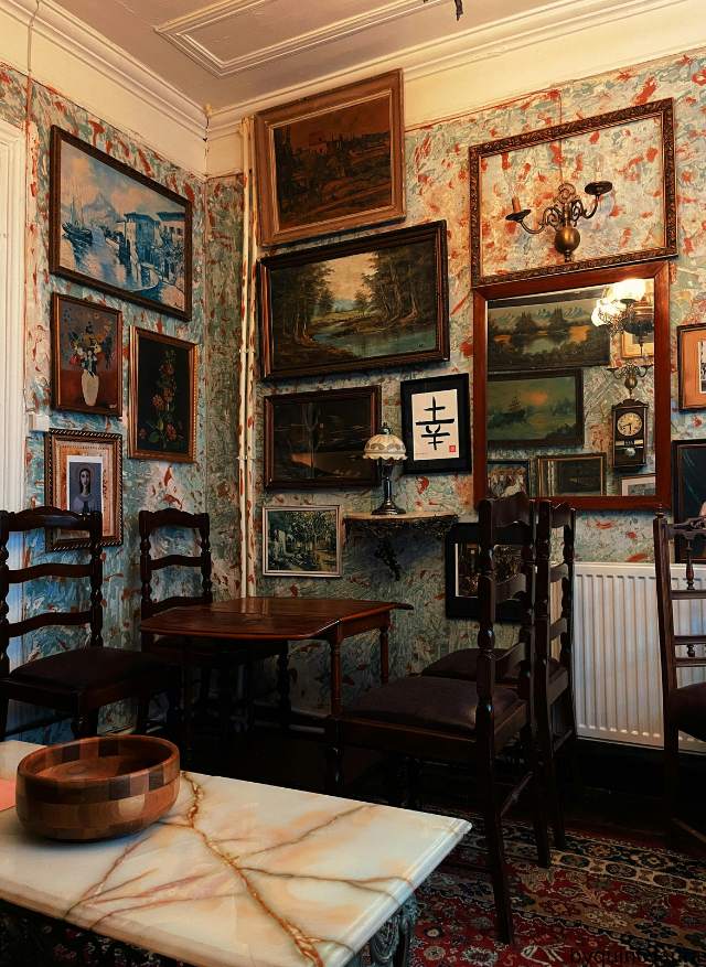 Vintage framed wall art displayed in a cozy living room