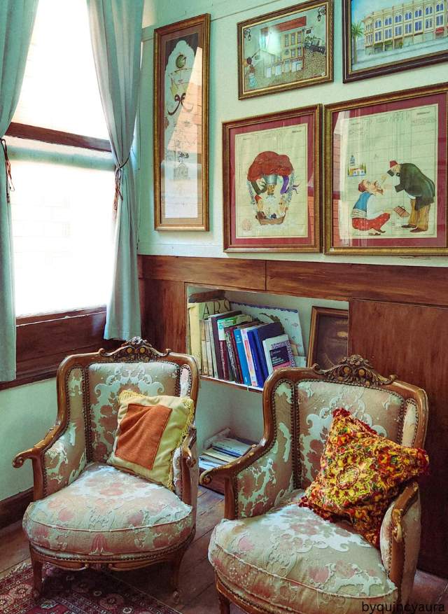 Vintage-inspired throw pillows in floral, plaid, and velvet on a cozy living room sofa