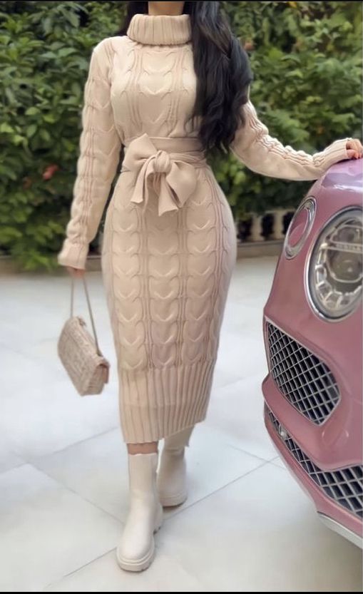 A lady wearing a long winter sweater dress