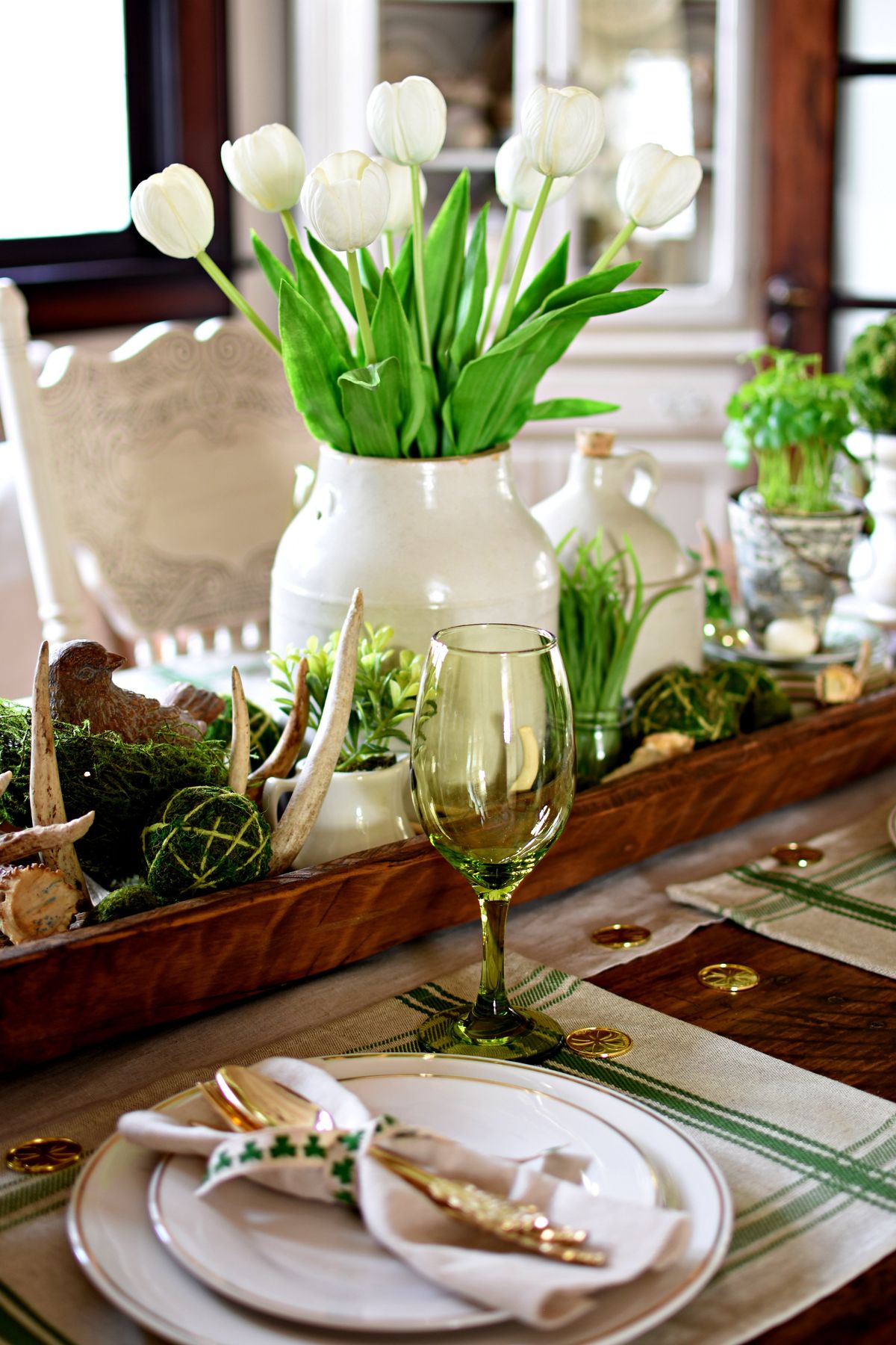 Wooden bowls and trays paired with green accents on a cozy St. Patrick’s Day table.