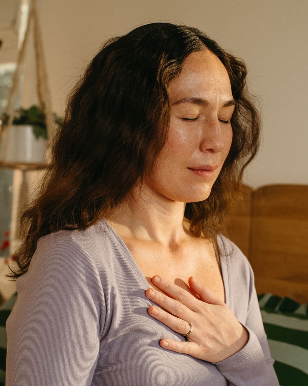A person practicing deep breathing before sleep