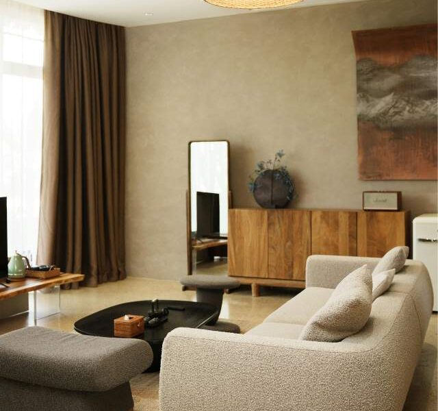 Small living room with light furniture, layered textures, Bright, airy, and stylish.