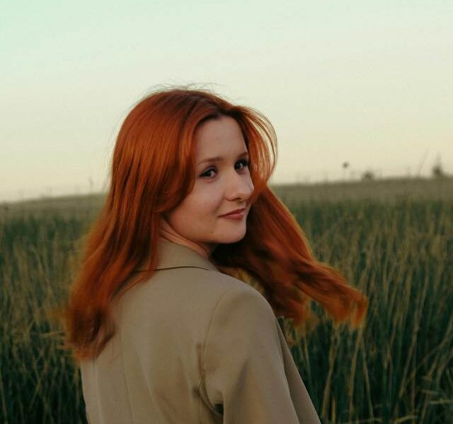A confident woman smiling and looking peaceful.