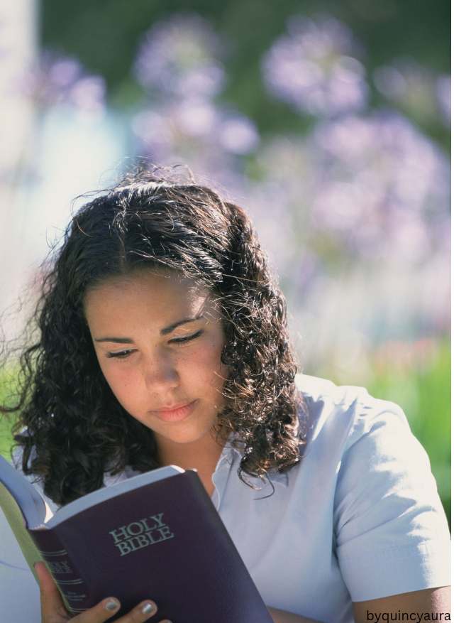 An image of a girl reading her bible.
