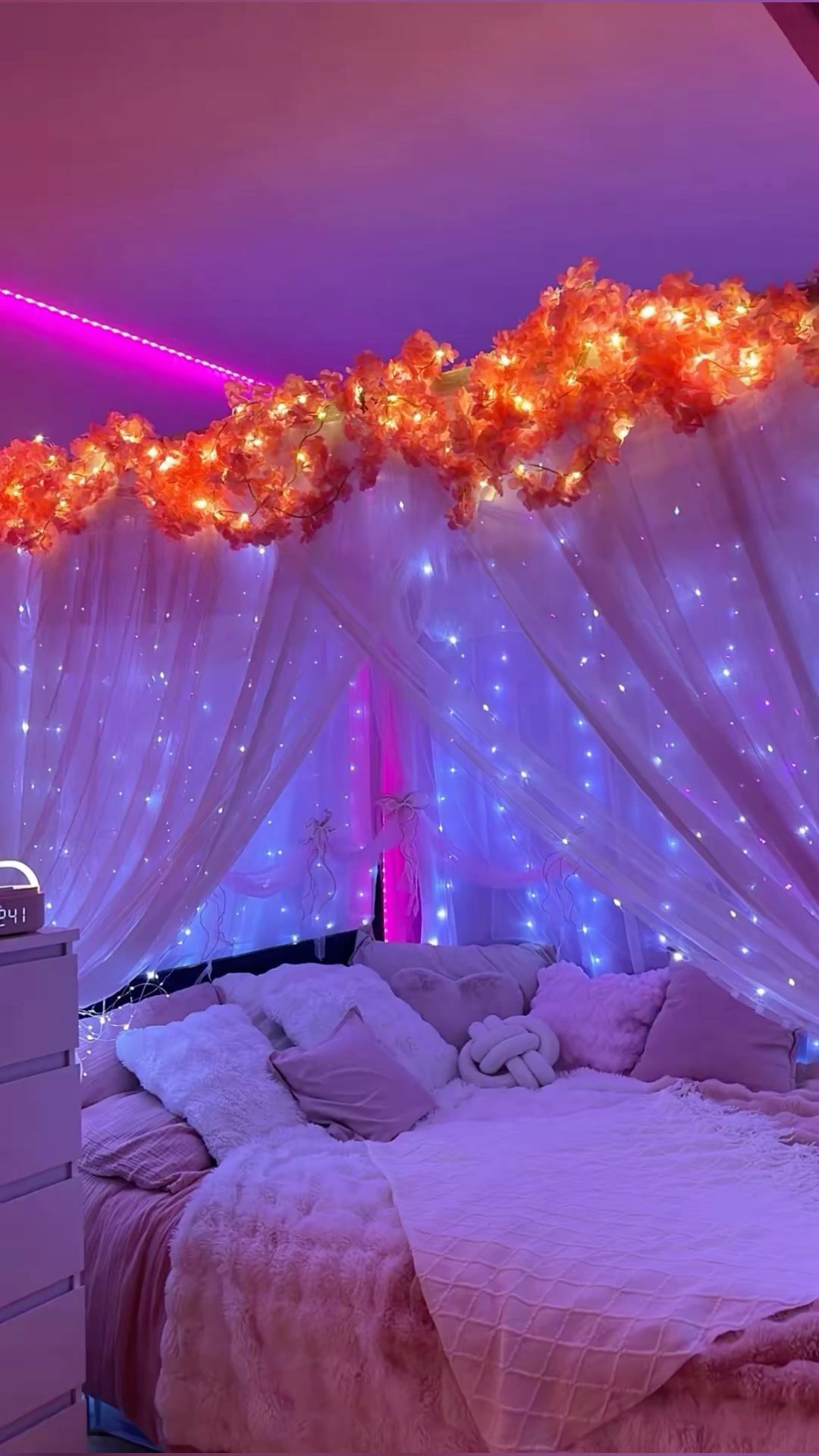 Teen girl bedroom with warm fairy lights hanging around the bed