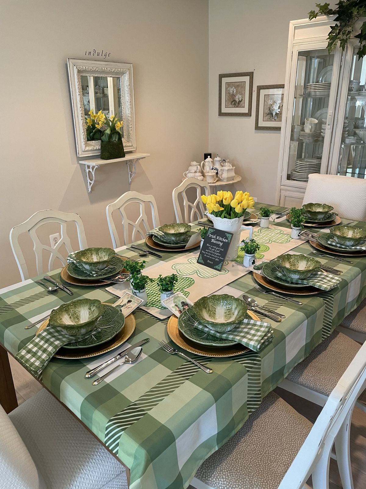 Neutral ceramic plates layered with soft green accent plates on a cozy St. Patrick’s Day dining table.
