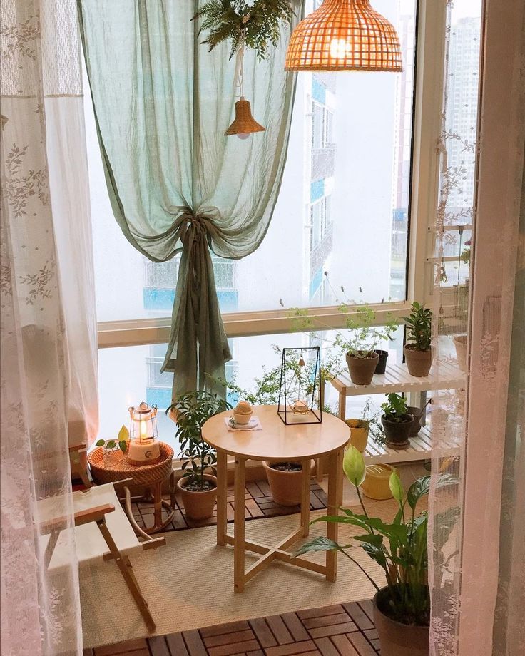 A bright studio apartment with large windows, sheer curtains, and plenty of natural light.