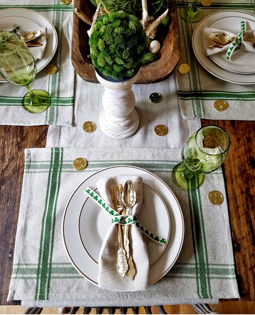 Cozy layered textures on a St. Patrick’s Day table using placemats, a green runner, and natural fibers.