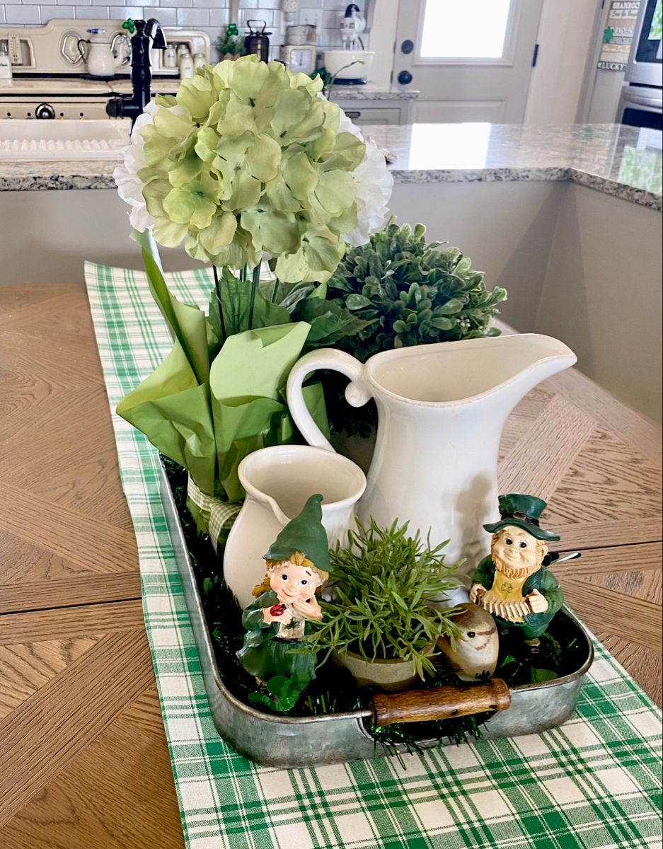 Small potted plants and greenery arranged on a coffee table 