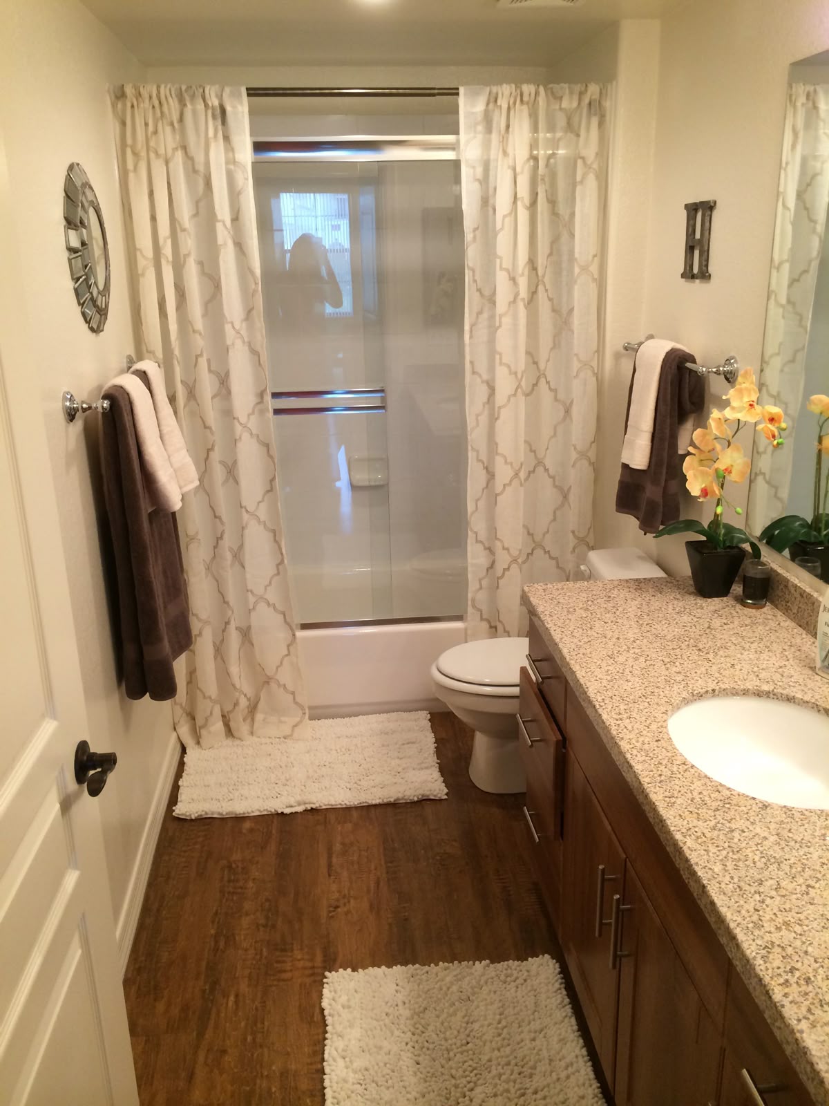 A small bathroom with a light-colored shower curtain.