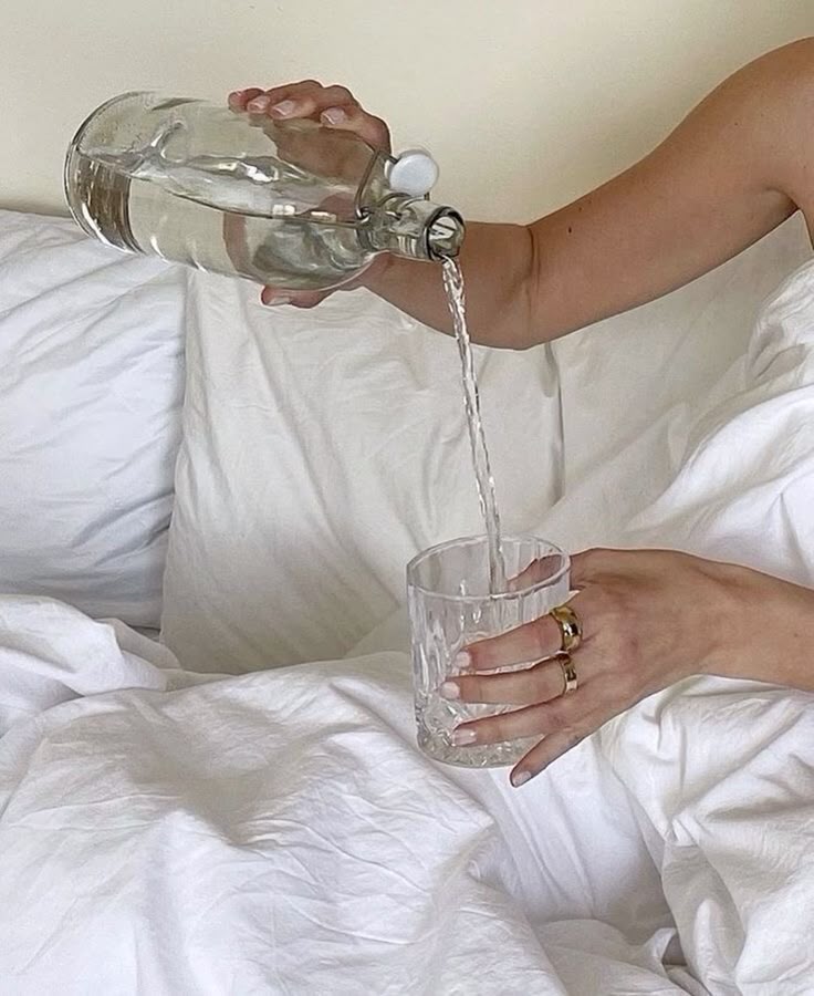 Glass of water in soft morning light, representing a simple morning wellness habit for hydration.
