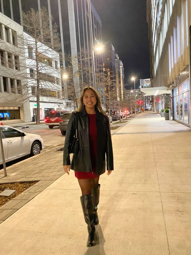 A lady putting on a red dress for a dinner night