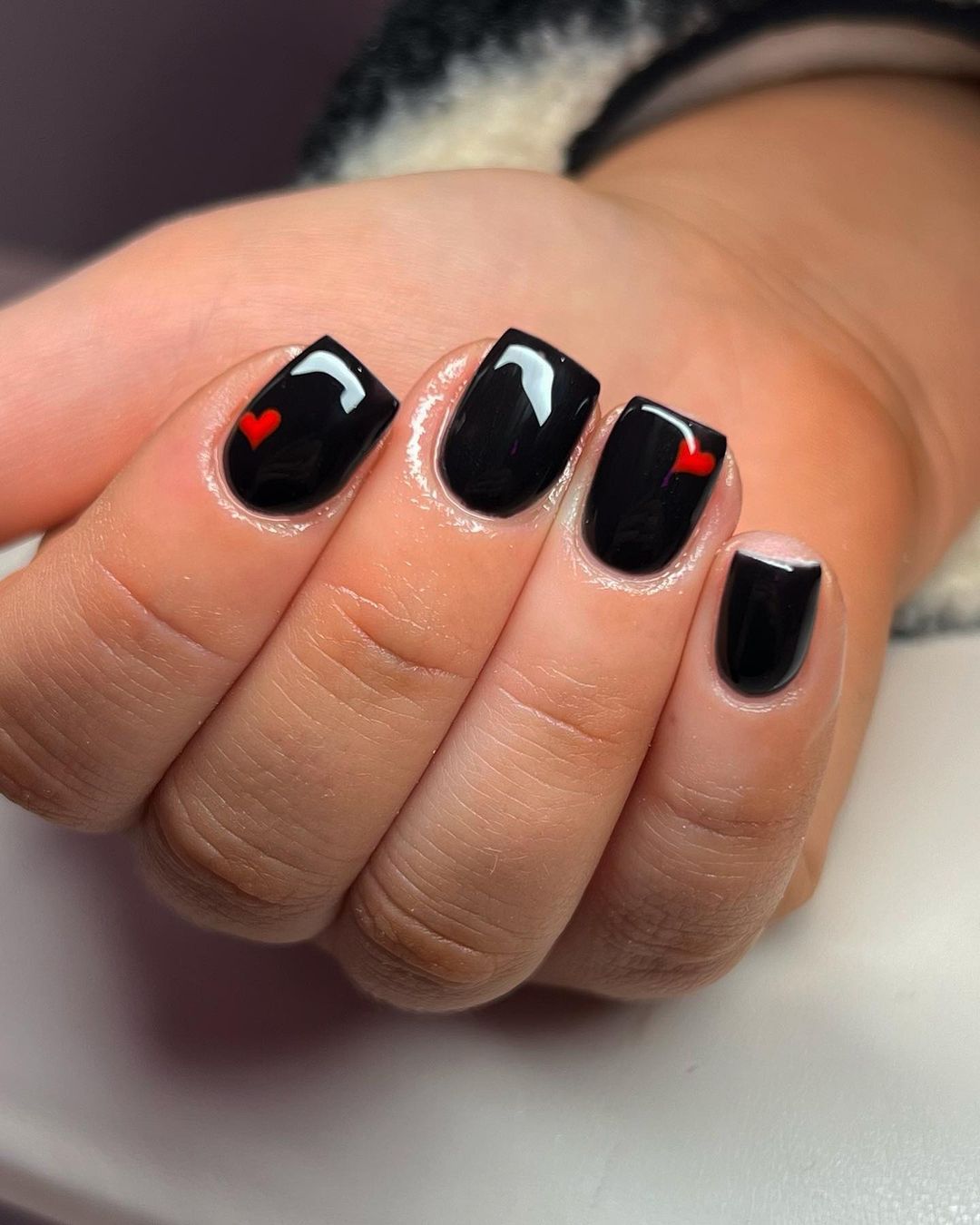 Black Valentine’s Day nails with red glitter tips.
