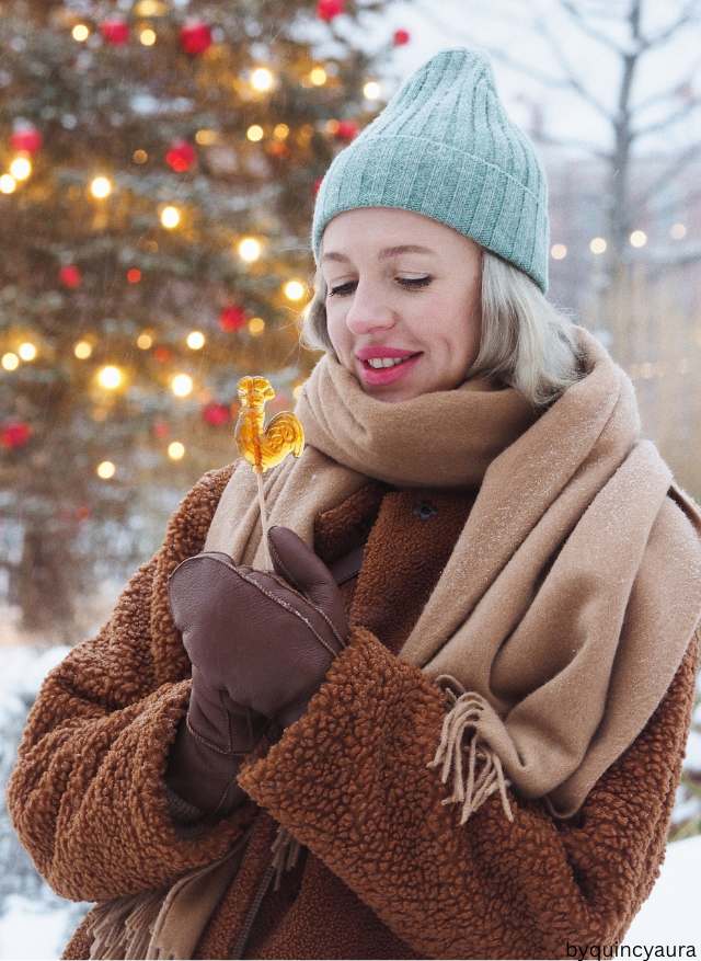 A lady wearing Winter accessories outfit scarf gloves beanie. 