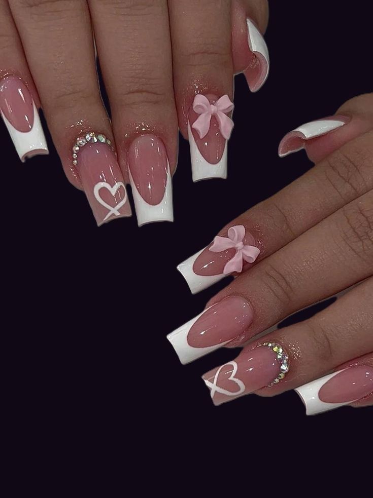 Nude base Valentine’s Day nails with glittery pink tips and rhinestone accent.