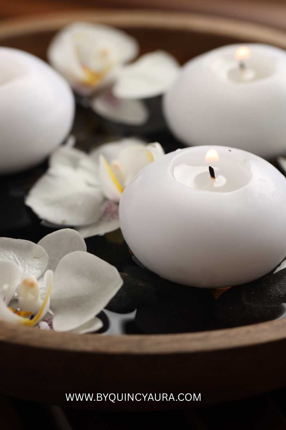 flower and candle placed in a bowl centerpiece.