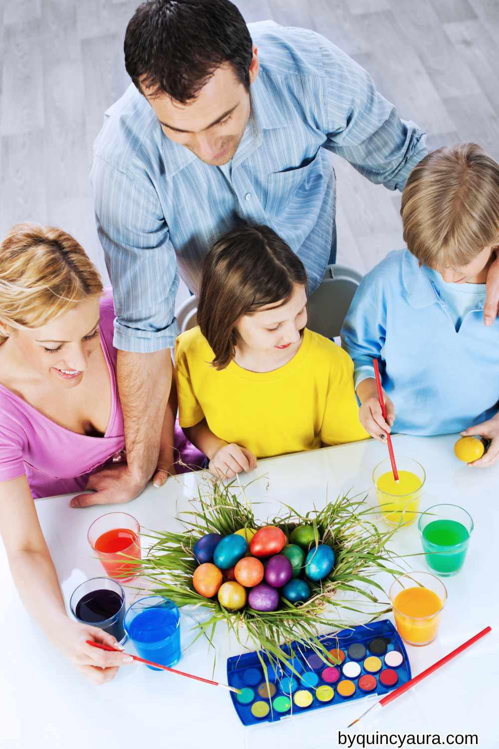 family painting Easter eggs together