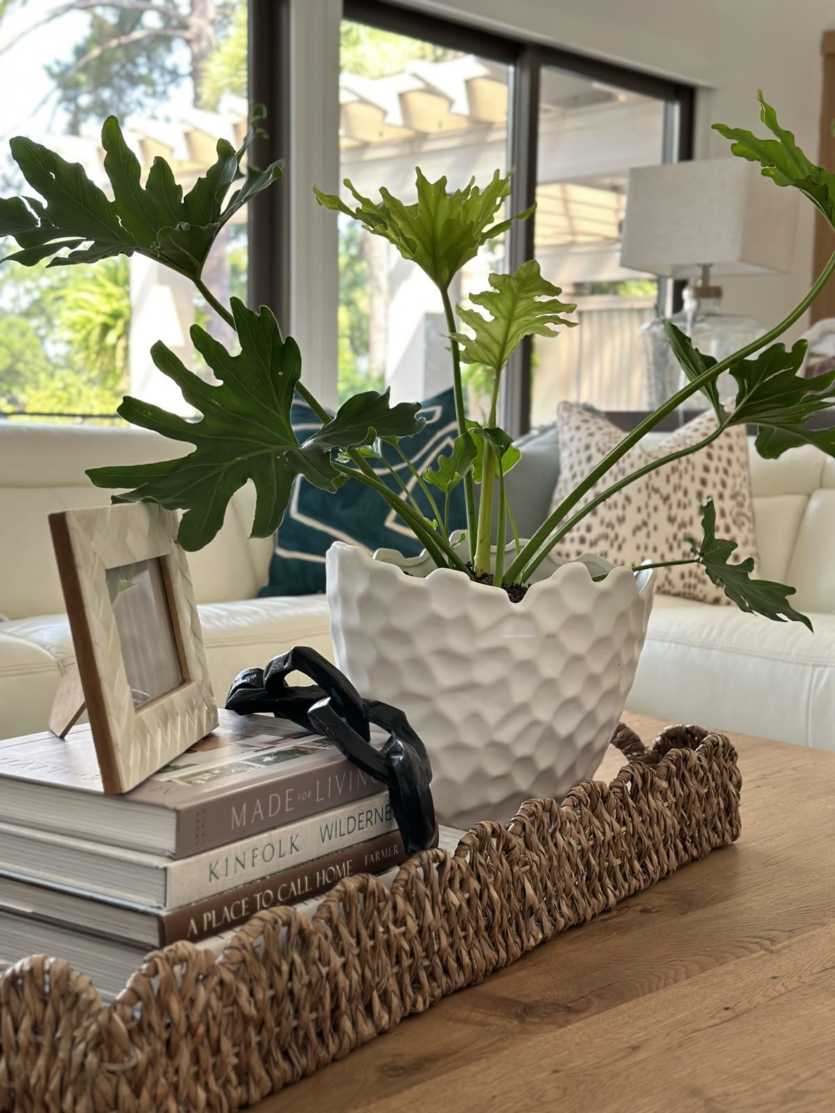decorative tray, a small plant, and a stack of books.