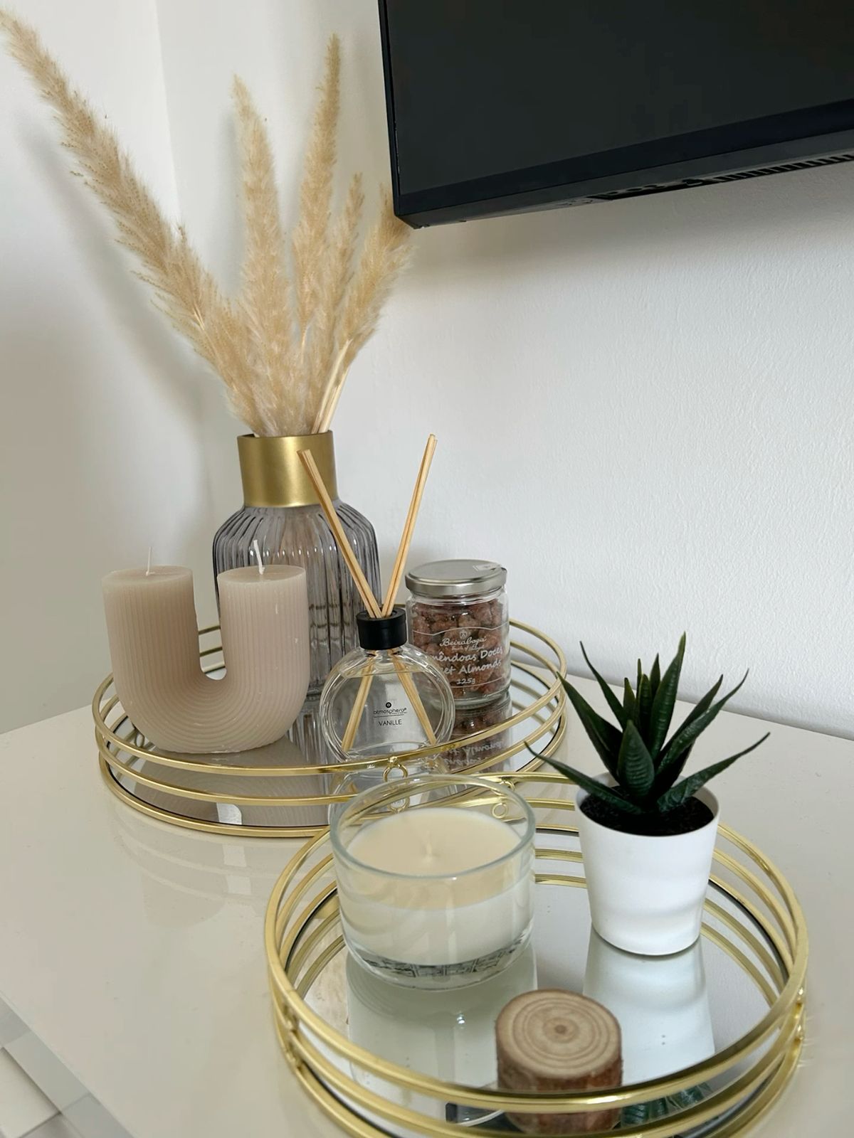 A tray filled with diffusers and scented candles.