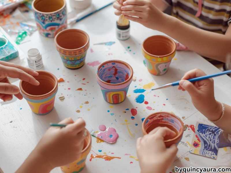 A bright, vibrant scene of kids decorating painted terra cotta pots with colorful patterns like polka dots, stripes, flowers, and rainbows using small paintbrushes, with hands actively adding details, surrounded by acrylic paints on a clean white or light wooden table